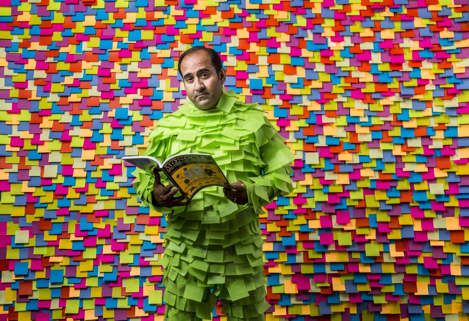 Rohit in a suit covered in Post-It Notes